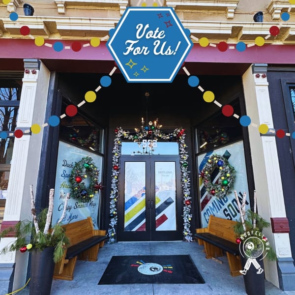 Oddfellows restaurant entrance decorated for the holidays with wreaths, garland, and a "Vote For Us!" sign.