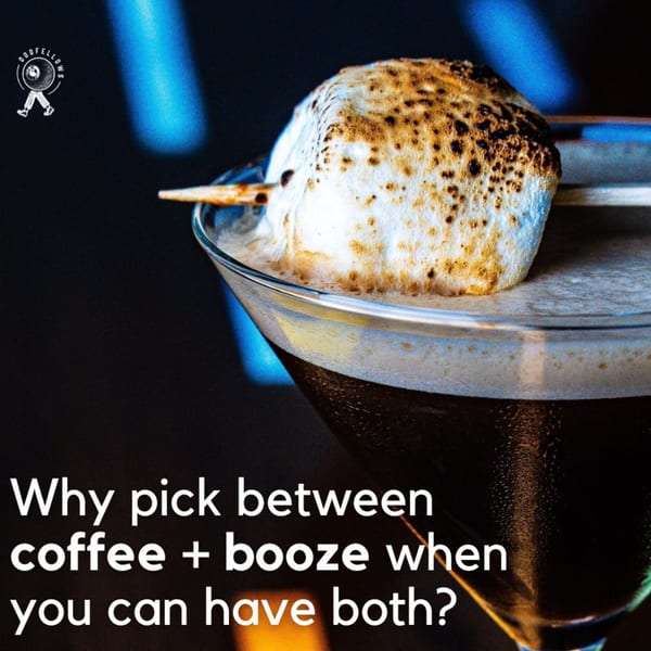 A dark cocktail in a martini glass, garnished with a toasted marshmallow on a skewer.